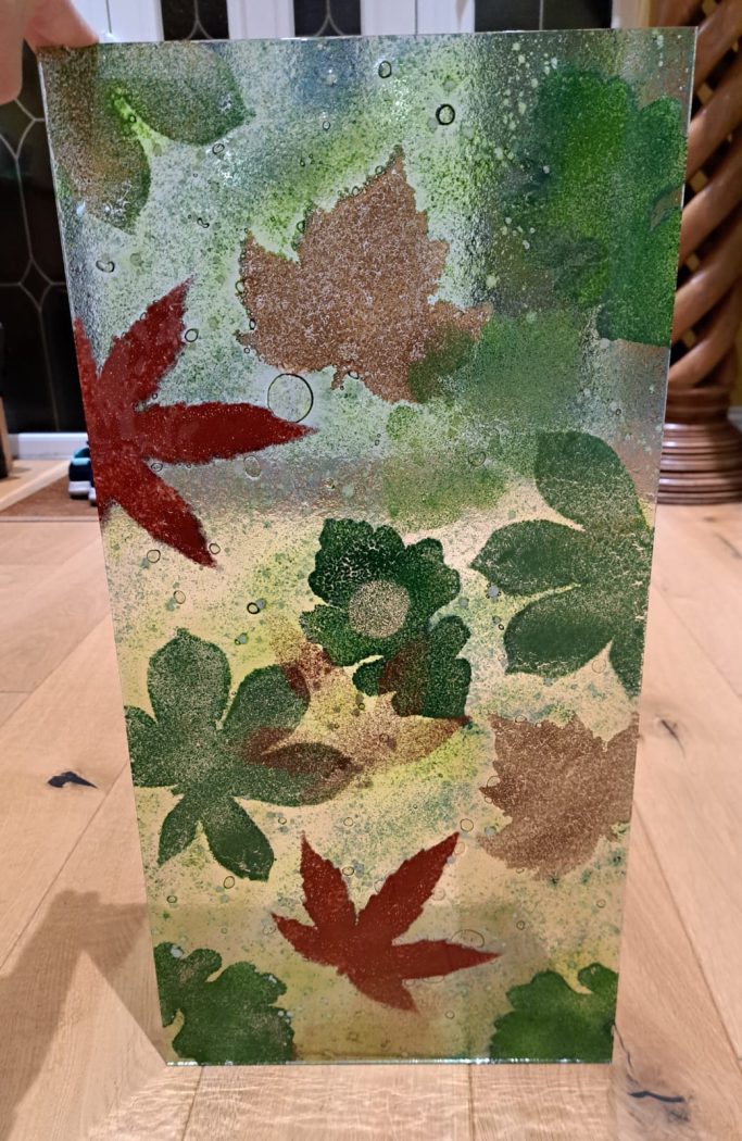 Enamelled Autumn leaves on glass panel